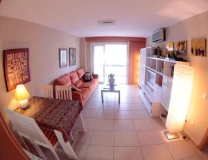 a living room with a couch and a table at Cullera - Primera Línea de Playa in Faro de Cullera