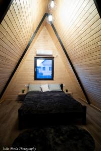 ein Schlafzimmer mit einem großen Bett im Dachgeschoss in der Unterkunft Roua A-frame in Deal