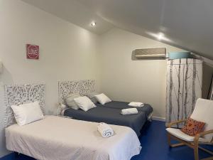 a room with two beds and a chair in it at Easy Stay In Espinho in Espinho