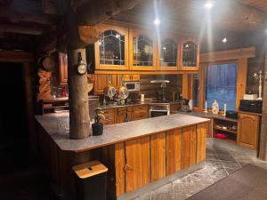 a kitchen with wooden cabinets and a counter top at Lepohetki in Loimaa