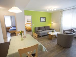 a living room with a couch and a table at Hardthof Sauerland in Schmallenberg +69 photos