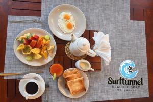 a table with two plates of breakfast foods and coffee at Surftunnel Beach Resort in Weligama +37 photos
