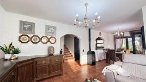 a living room with a couch and a chandelier at Bellavista in Begur +76 photos