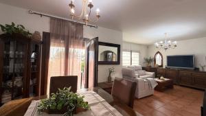 a living room with a dining table and a television at Bellavista in Begur
