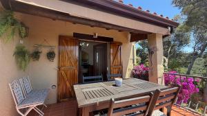 a wooden table and chairs on the porch of a house at Bellavista in Begur