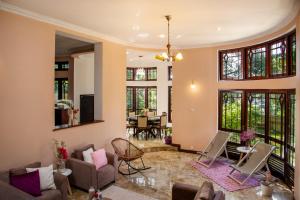 a living room with a couch and chairs at Whispering Trees in Kandy