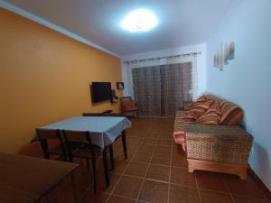 a living room with a couch and a table at MiRaRio in Vila Nova de Milfontes