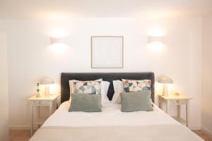 a bedroom with a large bed with two tables at Relax House in Estoril