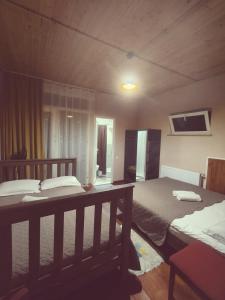 a bedroom with two beds and a tv on the wall at Apartment of mestia in Mestia