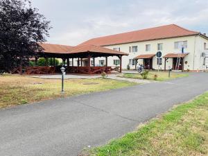 a building with a pavilion next to a road at Vila Zoppas Inn in Sînnicolau Mare
