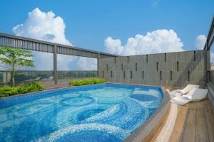 a swimming pool on the roof of a building at Four Points by Sheraton Kinshasa in Kinshasa