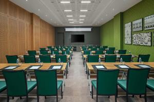 a conference room with tables and chairs and a screen at Four Points by Sheraton Kinshasa in Kinshasa +51 photos