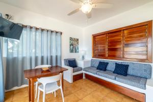 a living room with a couch and a table at Caribbean Villas Hotel in San Pedro