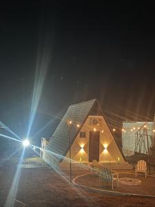 a small house with lights on it at night at Chalé serra da formiga in Riachuelo