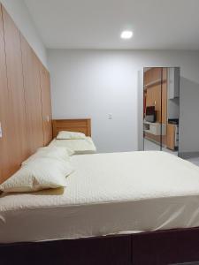 a bedroom with two beds and a mirror at Residencial Ibiapaba in Camocim