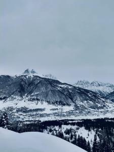 a snow covered mountain range with mountains in the background at Apartment of mestia in Mestia +7 photos