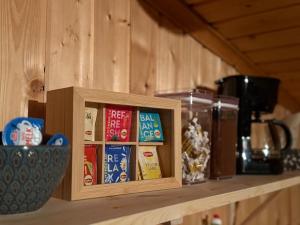 a wooden cabinet with some food on a shelf at Musekroken in Elverum