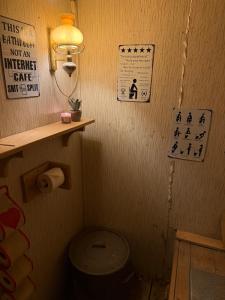 a small bathroom with a toilet and a light at Musekroken in Elverum +14 photos