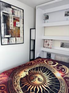 a bedroom with a bed with a painting on the wall at Le grand Large in Arcachon