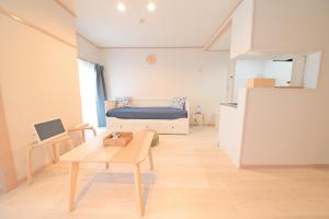 a small room with a bed and a table at Residence Hotel Kamoike in Kagoshima