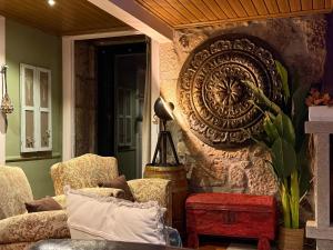 a living room with chairs and a wall at Quinta Santo Antonio do Rio in Celorico da Beira +33 photos