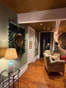 a living room with a chair and a table at Quinta Santo Antonio do Rio in Celorico da Beira