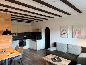 a living room with a couch and a table at Hardthof Sauerland in Schmallenberg