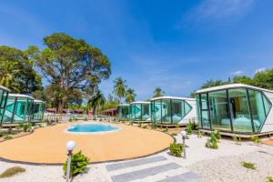 a resort with a swimming pool and a building at Aqua Soul de Pakbara in Ban Pak Ba Ra