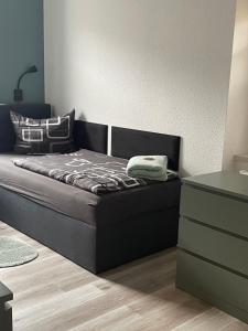 a black couch in a living room with a table at FeWo BiBo in Freiberg