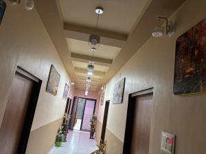 a hallway of a building with two doors and plants at hotal shahi palace in Jodāsar