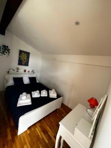 a bedroom with a black and white bed and a table at Stone house Skrivena in Pridraga +35 photos