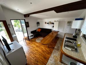 a kitchen and living room with a couch and a table at Stone house Skrivena in Pridraga