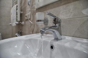 a sink with a faucet in a bathroom at Four brother in Tbilisi City