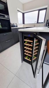 a kitchen with a wine rack with wine bottles at Sea Mourne View in Carlingford