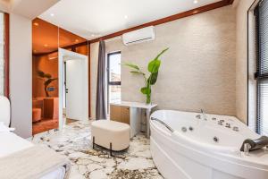 a bathroom with a white tub and a sink at Villa Verona in Durrës