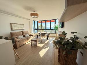 a living room with a couch and a table at New Caleta apartment seaviews in Caleta De Velez