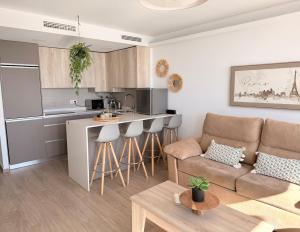 a living room with a couch and a kitchen at New Caleta apartment seaviews in Caleta De Velez +12 photos