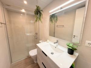 a bathroom with a sink and a shower and a toilet at New Caleta apartment seaviews in Caleta De Velez