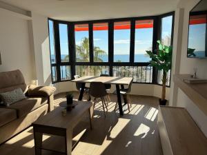 a living room with a table and a couch at New Caleta apartment seaviews in Caleta De Velez