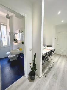 a bathroom with a sink and a table with a plant at Casa LL in Perugia