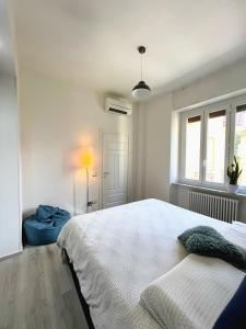 a white bedroom with a bed and a window at Casa LL in Perugia