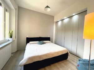 a bedroom with a bed with a black headboard at Casa LL in Perugia