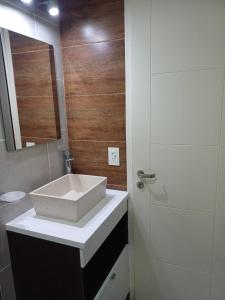 a bathroom with a white sink and a shower at Duplex De Los Padres in Playa Unión