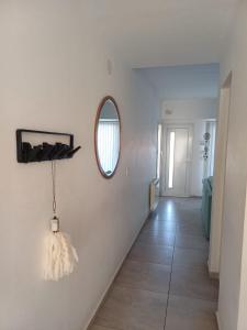 a hallway with a mirror and a white wall at Duplex De Los Padres in Playa Unión