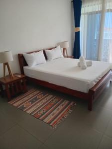 a bedroom with a bed and a rug at Zuri's Beachfront Bliss, With Beach Access -Sultan Palace in Mtwapa +170 photos