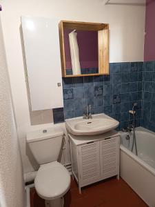 a bathroom with a toilet and a sink and a tub at AGRÉABLE STUDIO cabine PROCHE MER in La Londe-les-Maures
