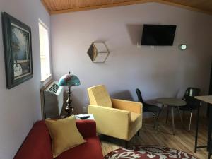 a living room with a red couch and a table at The Red Station Apartment #1 in Columbia Falls