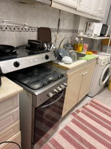 a kitchen with a stove and a sink with pots and pans at Benfica in Lisbon