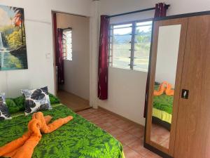 a bedroom with a teddy bear laying on a bed at Manatini lodge in Faie