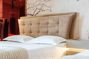 a bedroom with a large bed with white pillows at Villa Verona in Durrës